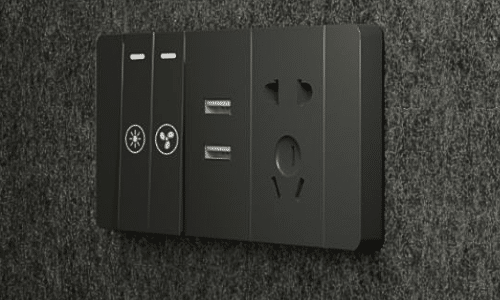 Close-up of an 8OOTH booth's control panel with light and fan switches, USB-A/C charging ports and a power outlet
