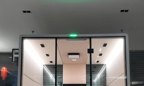 Booth entrance with a green occupancy indicator light above the door