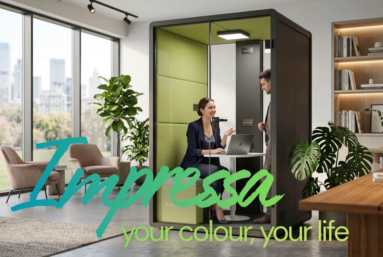 Woman working on a laptop inside a green-panelled 8OOTH Impressa booth while a colleague looks in, in a bright office
